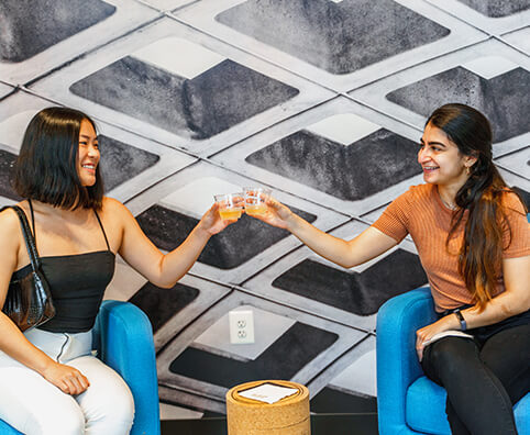 two women enjoying drinks together