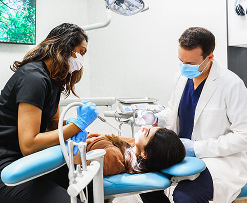 dentist and assistant caring for a patient