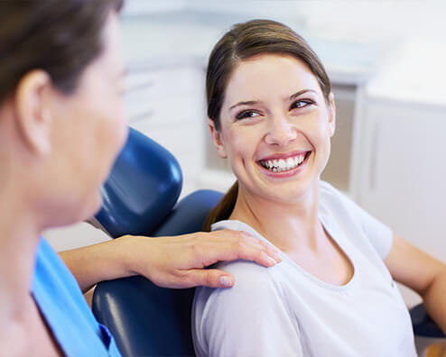 smiling woman getting her teeth cleaned